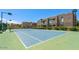 Well-maintained tennis court ready for play, surrounded by lush greenery and desert landscaping at 11260 N 92Nd St # 2023, Scottsdale, AZ 85260