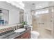 Bright bathroom featuring a glass-enclosed shower, decorative mosaic backsplash, and granite-topped vanity at 1285 E Cottonwood Rd, San Tan Valley, AZ 85140