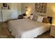 Bedroom featuring a queen bed, dresser, and neutral decor at 13807 N Garden Ct Dr, Sun City, AZ 85351