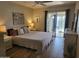 Bedroom featuring a queen bed, dressers, and sliding glass doors to the backyard at 13807 N Garden Ct Dr, Sun City, AZ 85351