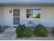 Inviting front porch featuring charming decor and well-maintained landscaping at 13807 N Garden Ct Dr, Sun City, AZ 85351