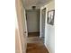 Hallway featuring wood-look floors and built-in storage cabinets at 13807 N Garden Ct Dr, Sun City, AZ 85351