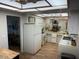 Clean kitchen features white appliances, cabinets, ample counter space, and a view to dining area at 13807 N Garden Ct Dr, Sun City, AZ 85351
