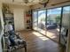 Bright living room with cozy seating, bookshelves, and sliding glass doors to a patio at 13807 N Garden Ct Dr, Sun City, AZ 85351