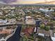 Expansive aerial view of a residential neighborhood featuring tree-lined streets and diverse home styles under a colorful sky at 1422 E Royal Palm Rd, Phoenix, AZ 85020