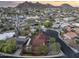 Aerial view of a home in a quiet neighborhood, featuring a red tile roof and solar panels at 1422 E Royal Palm Rd, Phoenix, AZ 85020
