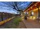 Spacious backyard featuring a covered patio, lush greenery, and decorative lighting for relaxing evenings at 1422 E Royal Palm Rd, Phoenix, AZ 85020