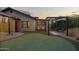 Landscaped backyard with putting green, rock features, outdoor seating, and cozy string lights at 1422 E Royal Palm Rd, Phoenix, AZ 85020