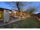 Expansive backyard with a patio, outdoor dining space, and lush landscaping, perfect for entertaining and relaxing at 1422 E Royal Palm Rd, Phoenix, AZ 85020
