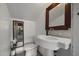 Classic bathroom with a pedestal sink, mirror, and natural light, offering a clean and simple design at 1422 E Royal Palm Rd, Phoenix, AZ 85020