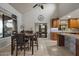 Open-concept dining area with tiled floors, pool table, and a seamless flow to the kitchen at 1422 E Royal Palm Rd, Phoenix, AZ 85020