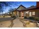 Inviting home with stone pathway, desert landscaping, covered porch, and warm exterior lighting at 1422 E Royal Palm Rd, Phoenix, AZ 85020