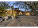An exterior view of the home showing the gravel yard, desert landscaping, and architectural details at 1422 E Royal Palm Rd, Phoenix, AZ 85020