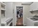 Bright laundry room showcasing washer and dryer leading to a walk-in closet at 1422 E Royal Palm Rd, Phoenix, AZ 85020