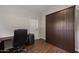 Home office features laminate flooring, a Murphy bed, and a neutral color scheme at 1422 E Royal Palm Rd, Phoenix, AZ 85020