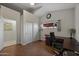 Bright home office with wood floors, closet, and a desk positioned next to a window at 1422 E Royal Palm Rd, Phoenix, AZ 85020