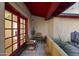 Covered patio with red accents, two chairs, and decorative plants at 1422 E Royal Palm Rd, Phoenix, AZ 85020