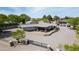 Aerial view of a stucco house featuring a large patio, mature trees, a gated entry, and ample parking at 15218 E San Tan Blvd, Gilbert, AZ 85298