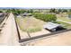 Aerial view showcases the property's large lot, horse facilities, including a covered stable and fenced area at 15218 E San Tan Blvd, Gilbert, AZ 85298