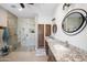 Bright bathroom features granite counters, dual sinks, wood accents, and modern glass shower at 15218 E San Tan Blvd, Gilbert, AZ 85298