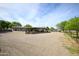 Exterior of the property showing an expansive gravel area and a covered patio at 15218 E San Tan Blvd, Gilbert, AZ 85298