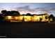 Attractive home exterior with landscape lighting, desert landscaping, and a spacious layout at twilight at 15218 E San Tan Blvd, Gilbert, AZ 85298