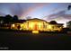 Well-lit home exterior with desert landscaping, spacious layout, and inviting front entrance at dusk at 15218 E San Tan Blvd, Gilbert, AZ 85298