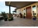 Inviting front entrance with stone columns, potted plants, and desert landscaping that enhances curb appeal at 15218 E San Tan Blvd, Gilbert, AZ 85298