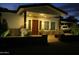 Beautifully illuminated front entrance with stone accents, desert landscaping, and a covered porch area at 15218 E San Tan Blvd, Gilbert, AZ 85298