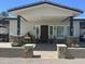 A covered front porch showcases stone pillars, a dark wood door, and well-placed planters at 15218 E San Tan Blvd, Gilbert, AZ 85298