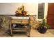 Close-up of a charming porch featuring decorative plants and a rustic welcome display at 15218 E San Tan Blvd, Gilbert, AZ 85298