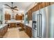Bright kitchen featuring stainless steel appliances, custom wood cabinets, granite countertops and modern fixtures at 15218 E San Tan Blvd, Gilbert, AZ 85298