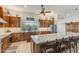 Well-lit kitchen features custom wood cabinets, stainless steel appliances, and a large island with barstool seating at 15218 E San Tan Blvd, Gilbert, AZ 85298