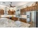 Spacious kitchen boasts custom wood cabinetry, stainless steel appliances, granite countertops and a breakfast bar at 15218 E San Tan Blvd, Gilbert, AZ 85298