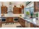 The kitchen features custom wood cabinets, stainless steel appliances, granite countertops and stylish modern fixtures at 15218 E San Tan Blvd, Gilbert, AZ 85298