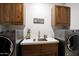 Well-appointed laundry room featuring modern appliances and white stone counters at 15218 E San Tan Blvd, Gilbert, AZ 85298