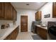 Well-appointed laundry room featuring wood cabinets and modern appliances at 15218 E San Tan Blvd, Gilbert, AZ 85298