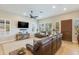 Comfortable living room with tiled floors, plantation shutters, and a plush leather sofa for relaxing or entertaining at 15218 E San Tan Blvd, Gilbert, AZ 85298
