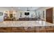 Open floor plan featuring a kitchen island with barstools, a dining area, and a comfortable leather sofa at 15218 E San Tan Blvd, Gilbert, AZ 85298