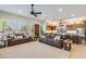 Inviting living room featuring tile floors, a wooden front door, and an open layout flowing into the kitchen at 15218 E San Tan Blvd, Gilbert, AZ 85298