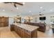 Expansive open floor plan includes a large kitchen island, dining table, and a comfortable leather sofa at 15218 E San Tan Blvd, Gilbert, AZ 85298
