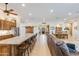 Open-concept living area with seating at a large kitchen island, a dining table, and a comfortable leather sofa at 15218 E San Tan Blvd, Gilbert, AZ 85298