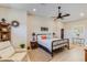 Comfortable main bedroom featuring a ceiling fan, cozy reading chair, and stylish decor at 15218 E San Tan Blvd, Gilbert, AZ 85298