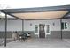 Charming covered porch with seating area, beautiful door, and accent lighting perfect for relaxing outdoors at 15218 E San Tan Blvd, Gilbert, AZ 85298