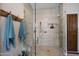 Modern glass shower with built-in bench, niche and wood accents at 15218 E San Tan Blvd, Gilbert, AZ 85298