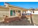 Charming backyard features a covered patio, sliding glass doors, and low-maintenance desert landscaping at 1684 Leisure World --, Mesa, AZ 85206