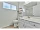 Well-lit bathroom with a white vanity, toilet, and decorative shelves at 1684 Leisure World --, Mesa, AZ 85206