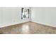 Bright bedroom with tile floors and a window with decorative curtains at 1684 Leisure World --, Mesa, AZ 85206