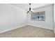 Bright dining area features tile flooring, a modern chandelier, and a window overlooking the yard at 1684 Leisure World --, Mesa, AZ 85206