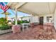 Inviting front porch with brick columns, wrought iron railings, and a decorative table, perfect for relaxation at 1684 Leisure World --, Mesa, AZ 85206
